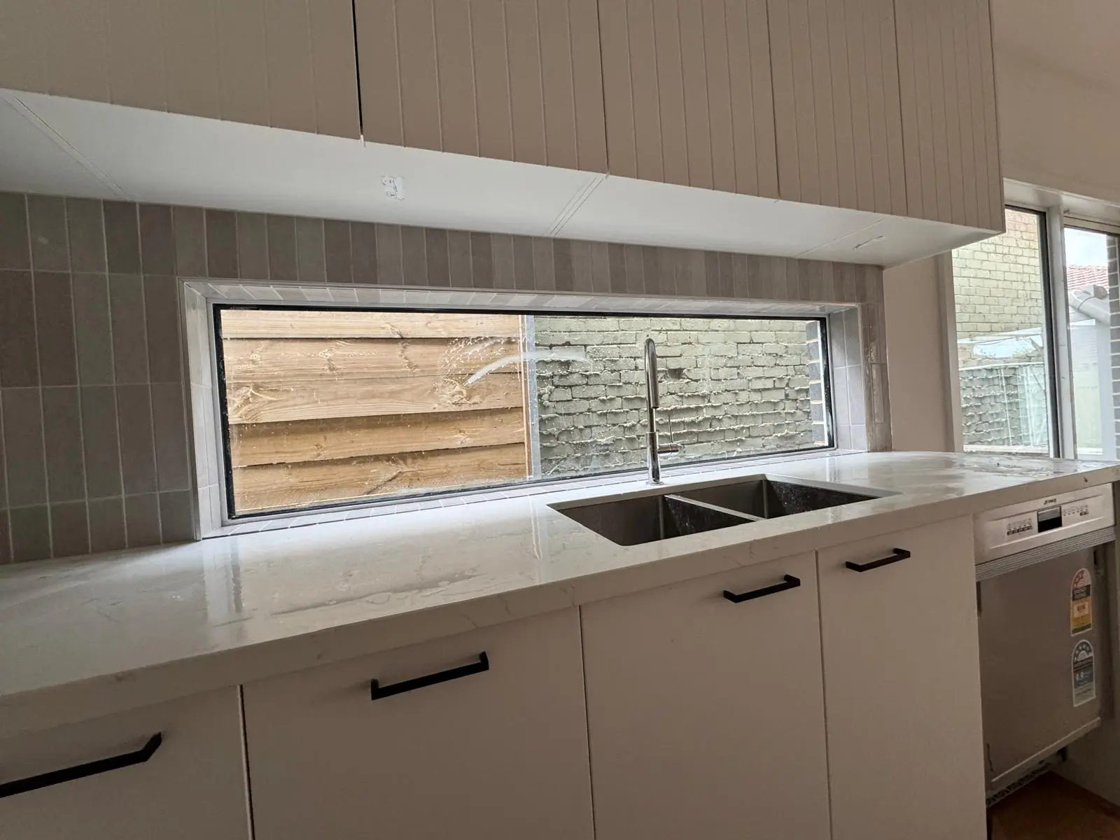 Kitchen splashback with white subway tiles
